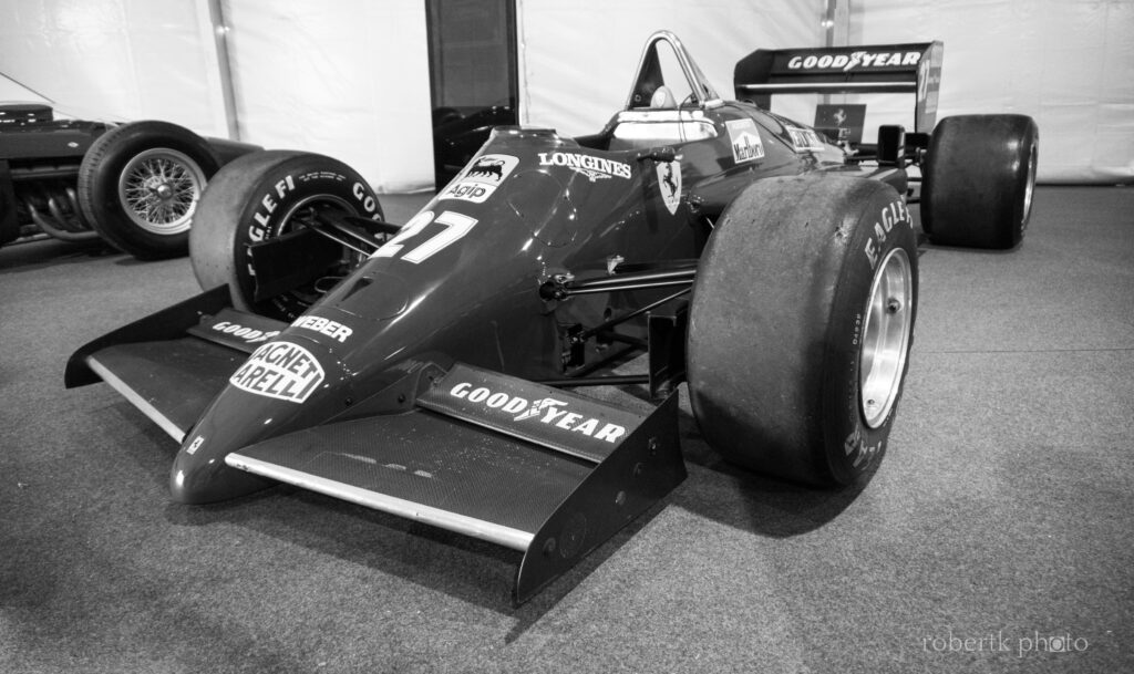 Front view of a classic Ferrari racing car in monochrome