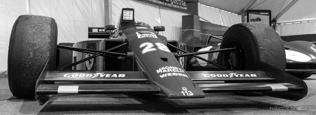 Monochrome side view of a classic racing car on display