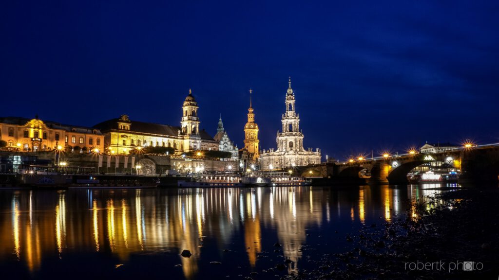 Illuminated Dresden riverfront buildings reflected in the water at night