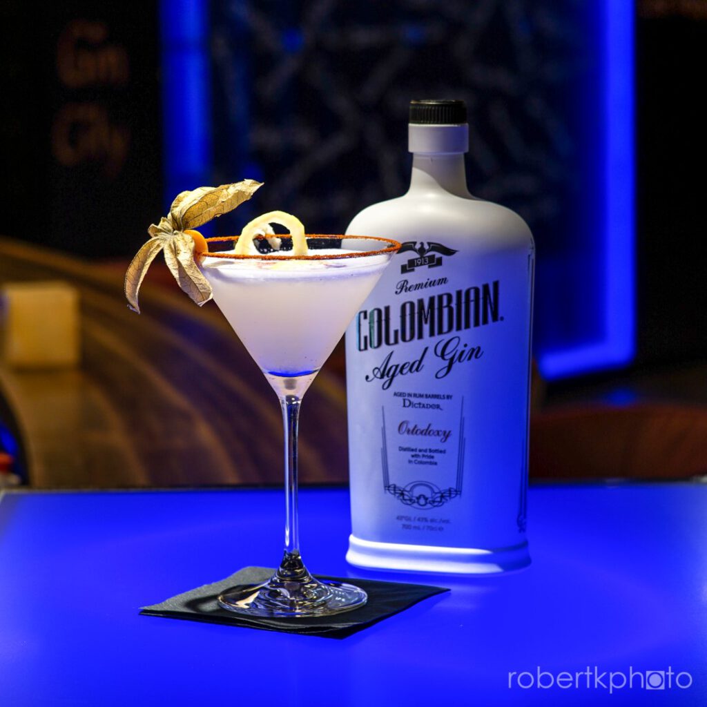 Martini-style cocktail beside a bottle of Colombian aged gin