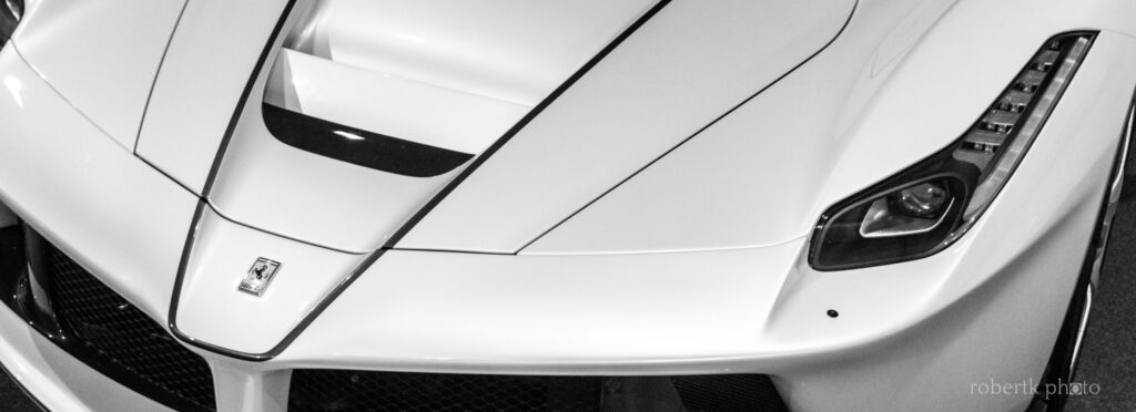 Close-up of the front hood and headlight of a white Ferrari